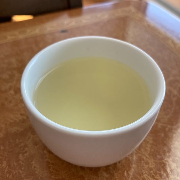 the tea, light green in color in a cup