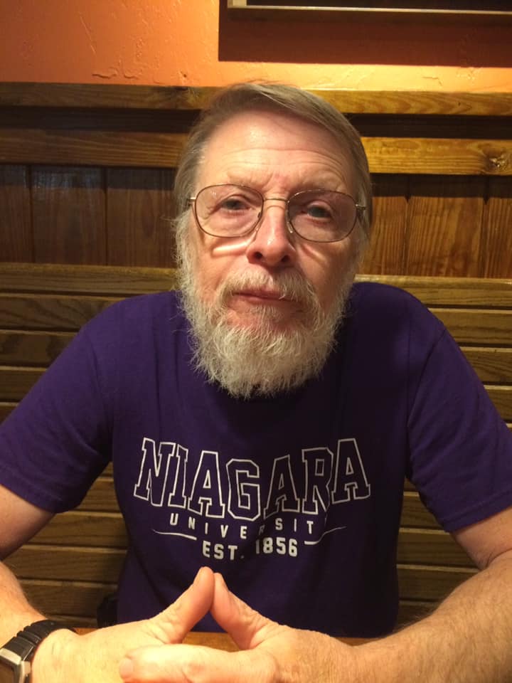 My dad looking at the camera while sitting at a table at Longhorn Steakhouse.