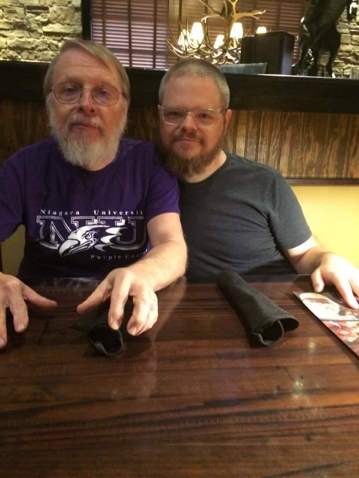My dad, and I, looking at the camera while sitting at a table at Longhorn Steakhouse.