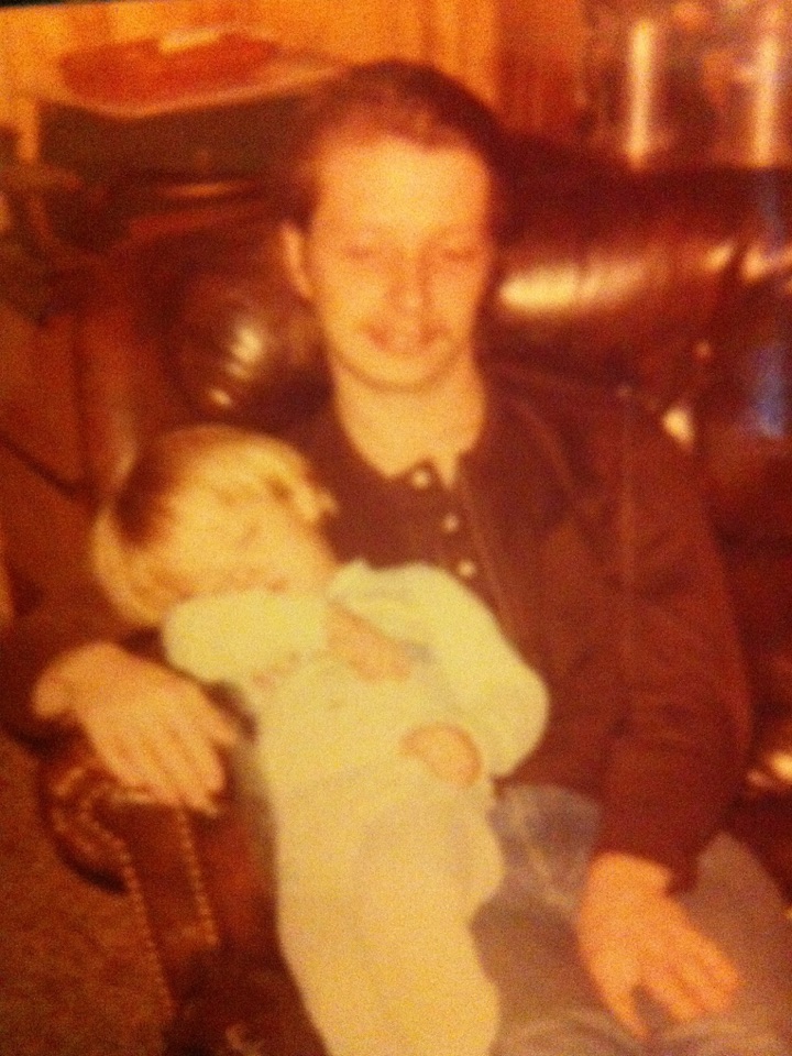 My dad at 28, or so, in 1978 sitting on his favorite chair with little young me sitting on his lap.