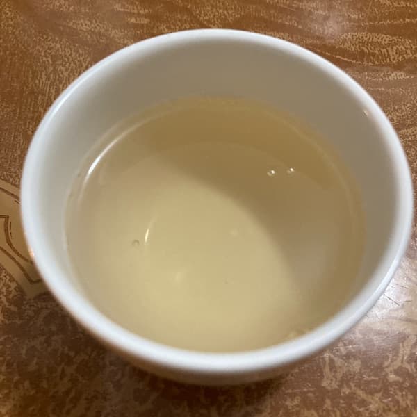 the tea, very light yellow in color, in a small white cup