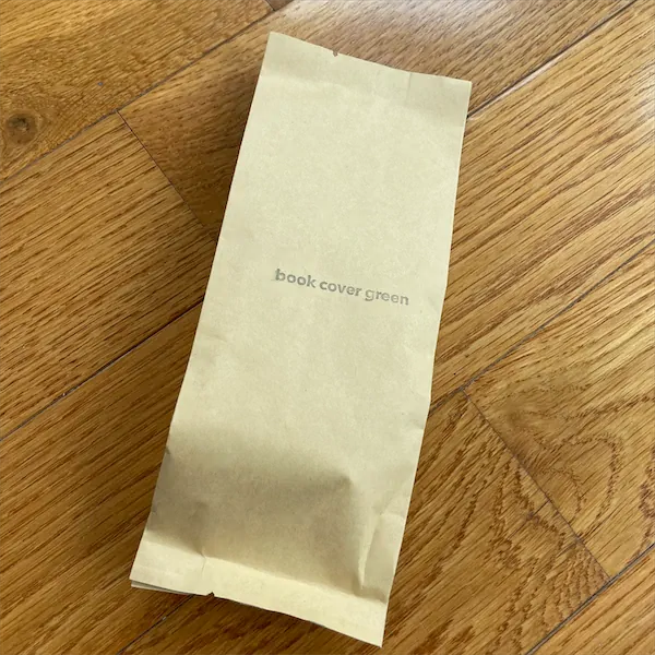 a small tan colored mylar package with the words book cover green displayed on it